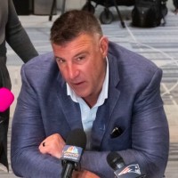 Mar 31, 2026; Phoenix, AZ, USA; New England Patriots head coach Mike Vrabel (center) speaks to reporters in the media during the 2026 NFL Annual League Meeting at the Arizona Biltmore. Mandatory Credit: Mark J. Rebilas-Imagn Images