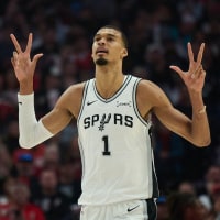Apr 26, 2026; Portland, Oregon, USA; San Antonio Spurs forward Victor Wembanyama (1) celebrates a three point basket by guard De'aaron Fox (4) during the first half of game four of the first round of the 2026 NBA Playoffs against the Portland Trail Blazers at Moda Center. Mandatory Credit: Troy Wayrynen-Imagn Images