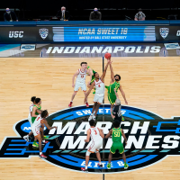 Southern California forward Evan Mobley fights for the opening tipoff with Oregon guard LJ Figueroa during a "March Madness" game in 2021.