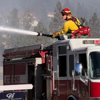 Fire crews battle the Upriver Fire on Tuesday, June 16, 2026, east of Spokane, Washington.