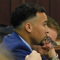 Blaise Taylor, a former Tennessee Titans scout, holds his gaze forward while his attorney Joshua Brand studies papers during jury selection in the Justice A. A. Birch Building in Nashville, Tenn. on June 22, 2026.