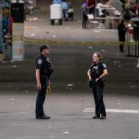 Police officers keep watch after a mass shooting at the Bite of Seattle food festival.