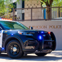 A police car parked in front of the Tucson Police Department