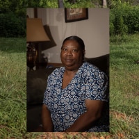 A portrait of a woman overlaid onto a landscape image showing a white PVC pipe stretched across a lawn.