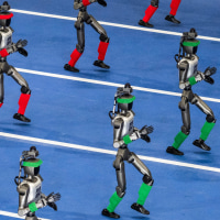 Humanoid robots walk in procession on a blue track