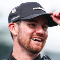 Kyle Kirkwood smile while lifting his cap outside