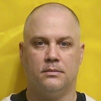 Tyrone Noling's mugshot on a yellow background