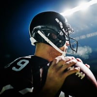 Image: Quarterback preparing to throw pass at night