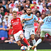 CARDIFF, WALES - AUGUST 16: Martin Odegaard of Arsenal is challenged by Rayan Cherki and Abdukodir Khusanov of Manchester City during the 2026 FA Community Shield match between Arsenal and Manchester City at Principality Stadium on August 16, 2026 in Cardiff, Wales. (Photo by David Price/Arsenal FC via Getty Images)