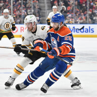 Dec 31, 2025; Edmonton, Alberta, CAN; Edmonton Oilers defenseman Darnell Nurse (25) and Boston Bruins center Elias Lindholm (28) are seen out on the ice during the second period at Rogers Place. Mandatory Credit: Walter Tychnowicz-Imagn Images