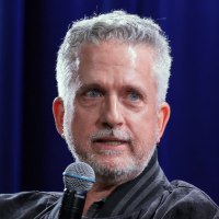 Bill Simmons speaks on a microphone.