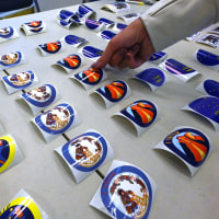 A person grabs a "I Voted" sticker from a table.