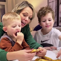 Dylan and her sons eating the pies.