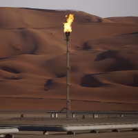 A flame burns off at an oil processing facility in Aramco's oilfield in the Rub' Al-Khali (Empty Quarter) desert in Shaybah, Saudi Arabia.