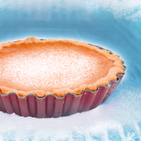 Pumpkin pie within a frozen freezer with snow