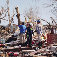 Search and rescue team members continue to look for tornado victims in Rolling Fork, Miss.