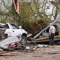 A man surveys the debris outside his destroyed home on April 5, 2023 in Glenallen, Mo.