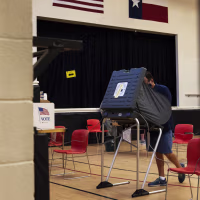 A person casts their ballot at an early voting polling location in Houston