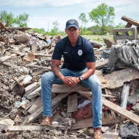 Police officer Robert Barfield Jr. at a destroyed mobile home park where he rescued tornado victims in Rolling Fork, Miss.