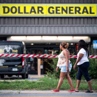 Image: People walk past the Dollar General store where three people were shot and killed the day before on Aug. 27, 2023 in Jacksonville, Fla.