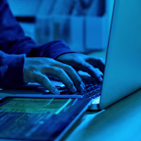 Wanted hackers coding virus ransomware using laptops and computers. Cyber attack, system breaking and malware concept.