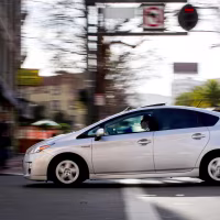 A Toyota Prius crossing a street.