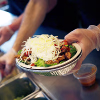 An employee prepares a burrito bowl at a Chipotle Mexican Grill.