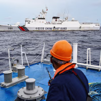 A China Coast Guard ship is seen from the Philippine Coast Guard vessel BRP Cabra in the South China Sea