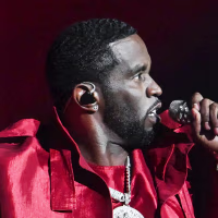 Sean "Diddy" Combs performs on stage, wearing all red