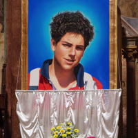 An image of 15-year-old Carlo AcutiS is unveiled during his beatification ceremony at St. Francis Basilica in 2020.
