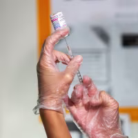 A healthcare worker prepares a dose of a Covid-19 vaccine
