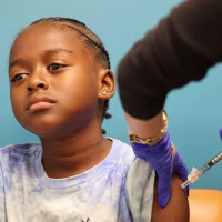 A child receives a COVID-19 vaccination in Culver City, Calif., on Sept. 23, 2025. 