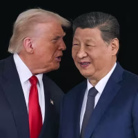 President Donald Trump talks to China's President Xi Jinping after their talks at the Gimhae Air Base in Busan, South Korea, on October 30, 2025.