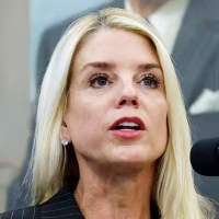 From left, Pam Bondi (speaking at a podium), and Donald Trump
