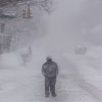 People walk in the snow