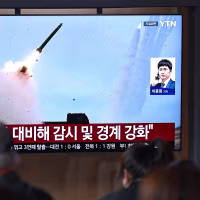 A news broadcast with file footage of a North Korean missile test, at a train station in Seoul on April 19.