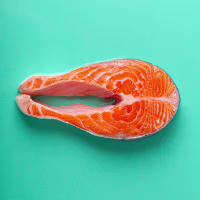 Raw fresh fish salmon steak top view on blue clean background from