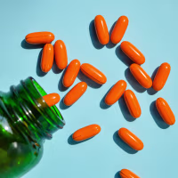 soft capsules poured from a pill bottle