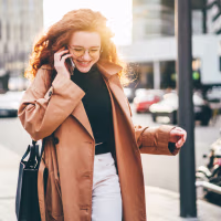 Woman walking and talking on the phone to improve mental health
