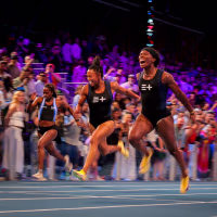 Barbados Tristan Evelyn cheers as she wins the women's 100m next to Jamaica's Denae McFarlane and US's Shania Collins.