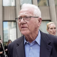 Frank stronach, outside a courthouse.