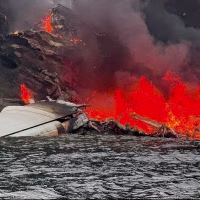 The Kenmore Air seaplane that made an emergency landing in North Beach Shallow Bay before catching fire.
