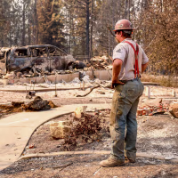A worker pauses to look at the debris.