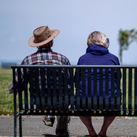 People sit on a bench in Hercules, California, US, on Thursday, June 20, 2024. 
