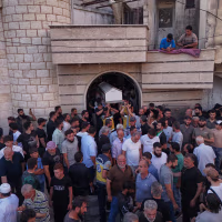 Mourners carry the coffin of Mohammad Ghamira