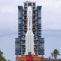 A rocket and booster are displayed upright 