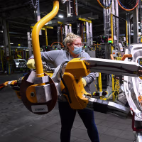 A workers welds vehicle doors at the General Motors assembly plant in Oshawa, Ontario, in 2021. 