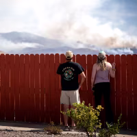 Residents look at the Hawk Fire burning on Aug. 23, 2026 in Reno, Nev.