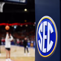 The SEC logo is seen while people play on the court.