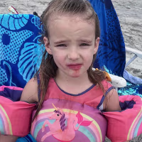 A 5 year old girl at the beach.